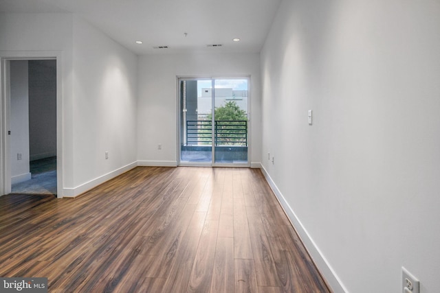 empty room with dark hardwood / wood-style floors