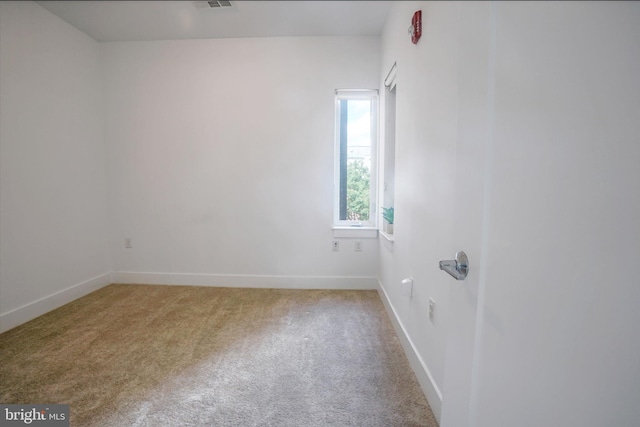 empty room featuring light carpet