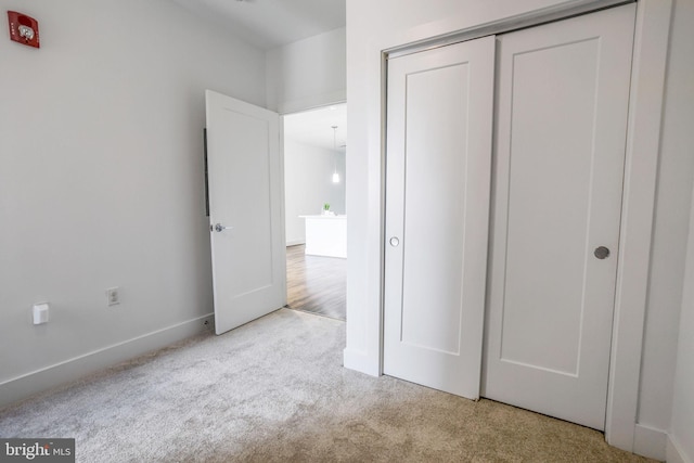 unfurnished bedroom with light hardwood / wood-style floors and a closet