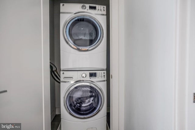 laundry area with stacked washer and dryer