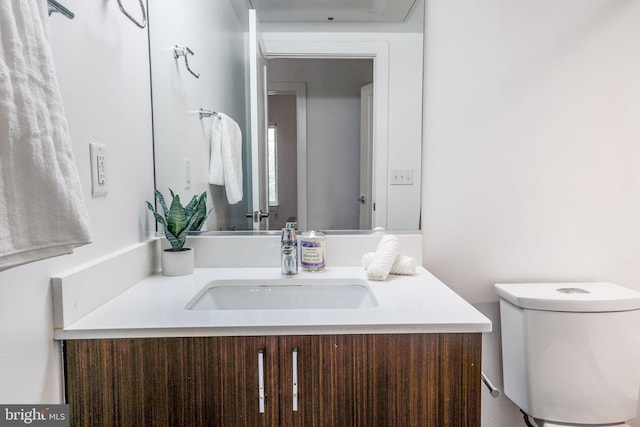 bathroom with toilet and vanity