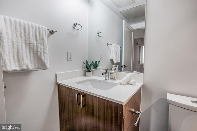 bathroom with toilet and vanity