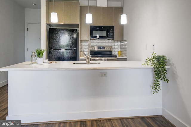 kitchen with hanging light fixtures, backsplash, sink, dark hardwood / wood-style floors, and black appliances