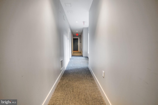 hallway featuring dark carpet