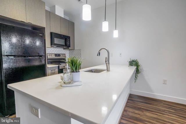 kitchen featuring pendant lighting, tasteful backsplash, black appliances, dark hardwood / wood-style floors, and sink