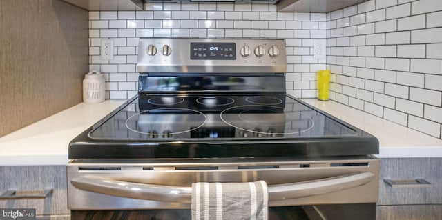 kitchen featuring backsplash and stainless steel range with electric stovetop