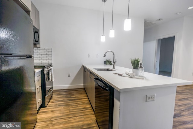 kitchen featuring hanging light fixtures, tasteful backsplash, hardwood / wood-style flooring, and black appliances