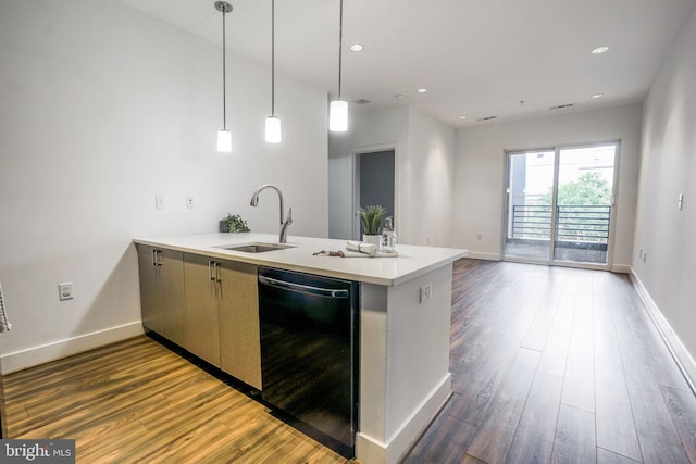 kitchen with pendant lighting, light hardwood / wood-style flooring, dishwasher, and sink