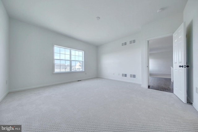 spare room with light carpet