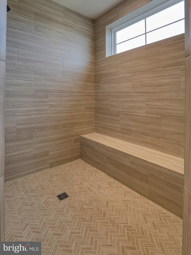 bathroom with tiled shower