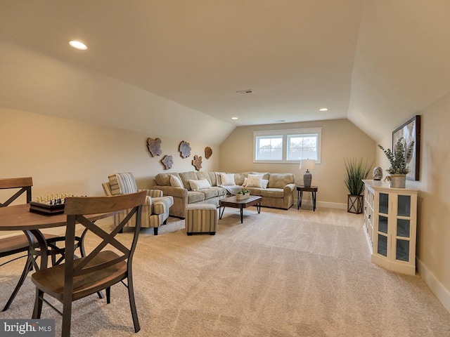 living room featuring light colored carpet and vaulted ceiling