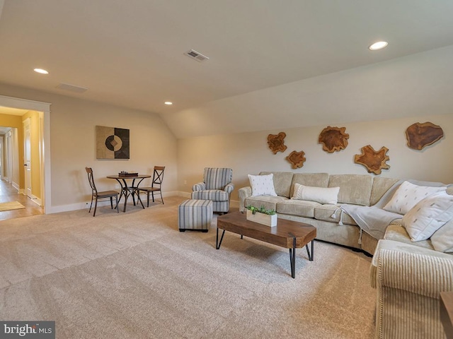 carpeted living room featuring lofted ceiling