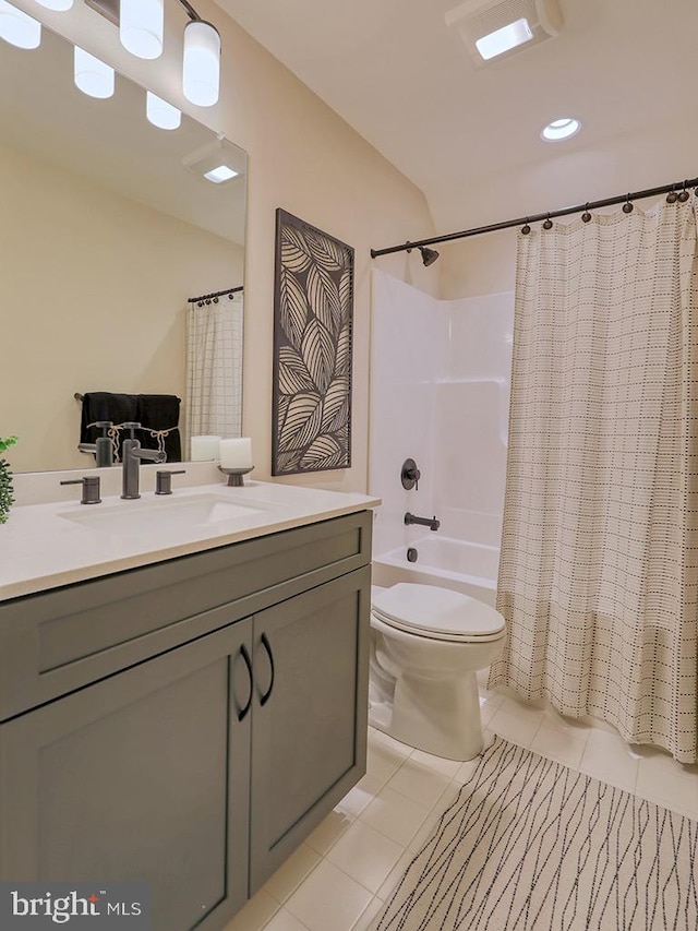 full bathroom featuring toilet, tile floors, shower / bathtub combination with curtain, and vanity