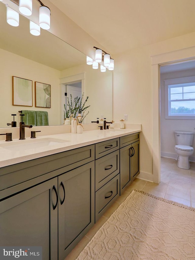 bathroom featuring dual bowl vanity, toilet, and tile floors