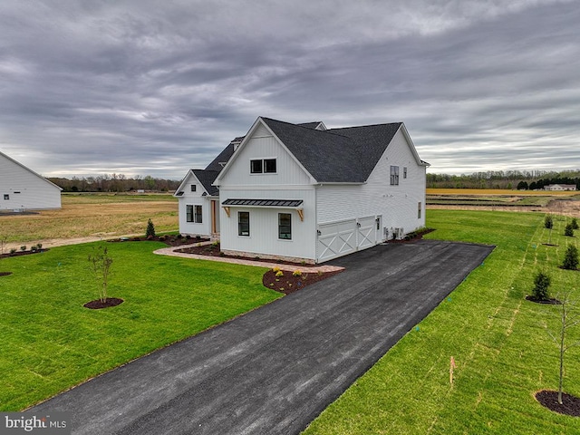 modern farmhouse style home with a front lawn