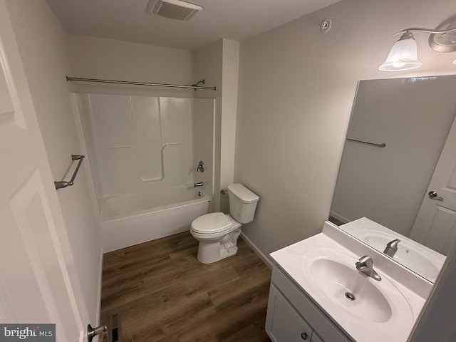 full bathroom with visible vents, toilet, shower / tub combination, wood finished floors, and vanity