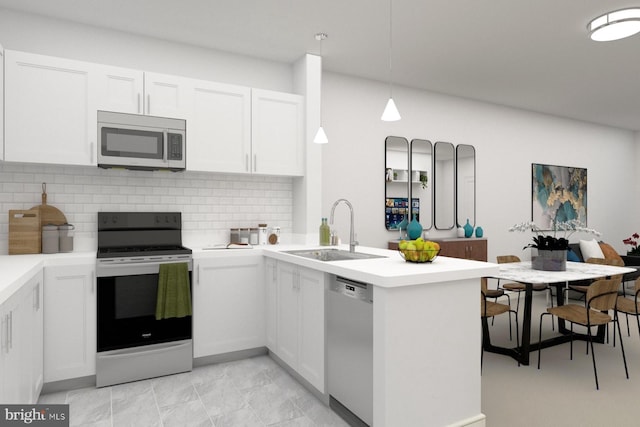 kitchen featuring white cabinetry, stainless steel appliances, pendant lighting, sink, and light tile flooring