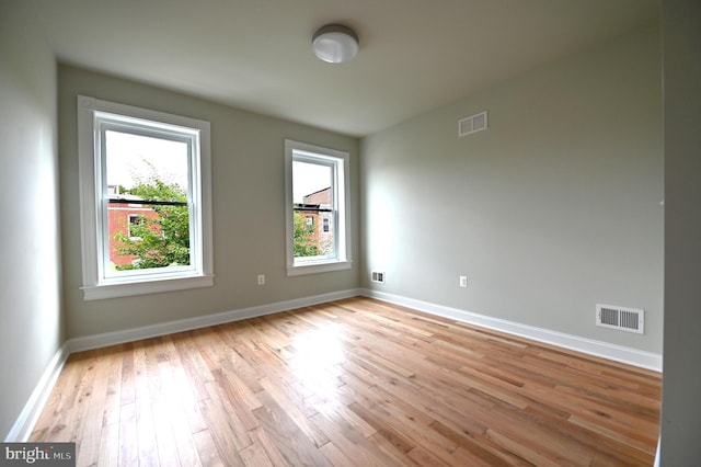 unfurnished room featuring light hardwood / wood-style floors