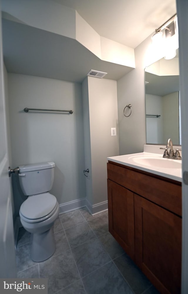 bathroom featuring toilet, tile flooring, and oversized vanity