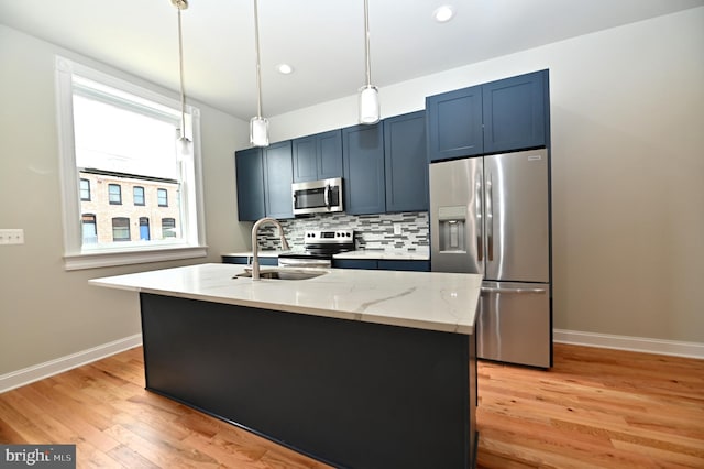 kitchen featuring light hardwood / wood-style flooring, stainless steel appliances, and a healthy amount of sunlight