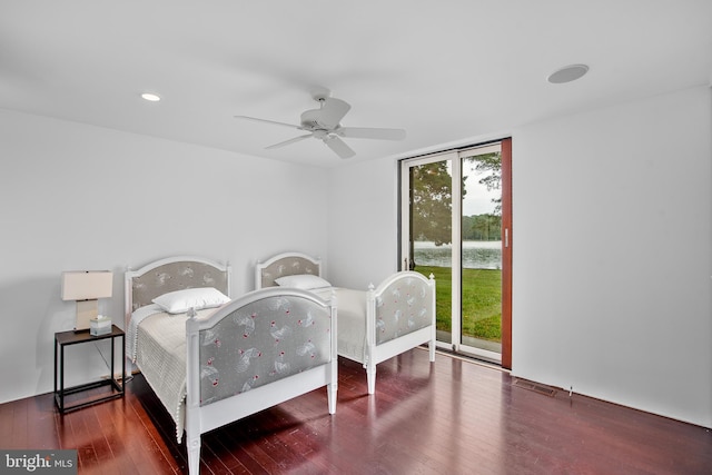 bedroom featuring ceiling fan, dark wood-type flooring, and access to outside