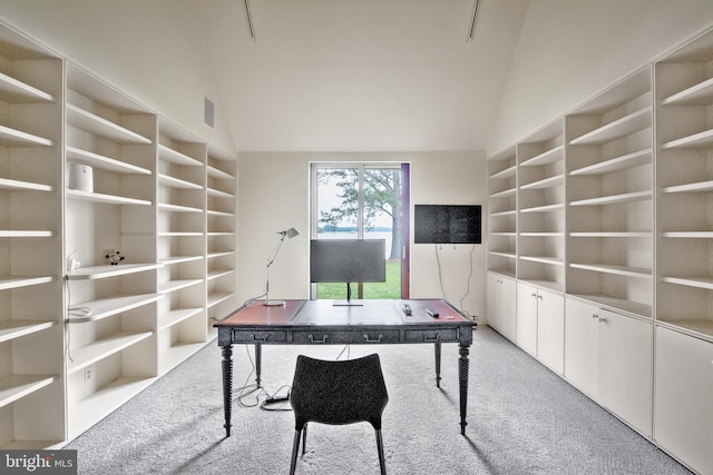 carpeted office space with vaulted ceiling