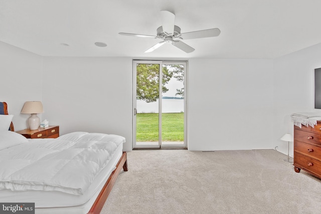 bedroom featuring ceiling fan, access to exterior, and light carpet