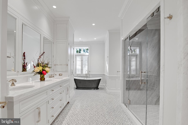 bathroom featuring crown molding, vanity, and shower with separate bathtub