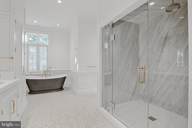 bathroom with crown molding, vanity, and independent shower and bath