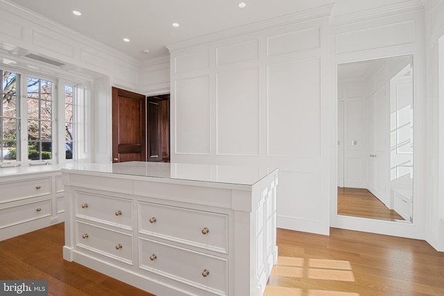 interior space featuring hardwood / wood-style floors and ornamental molding