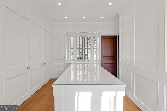 walk in closet with light hardwood / wood-style floors