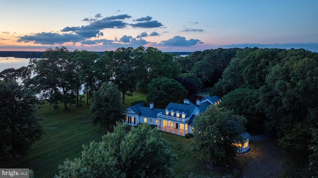 aerial view at dusk with a water view