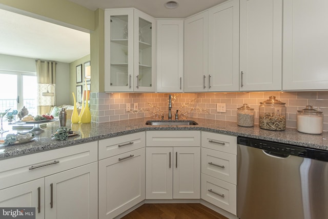 kitchen with dark wood-type flooring, sink, white cabinets, and stainless steel dishwasher