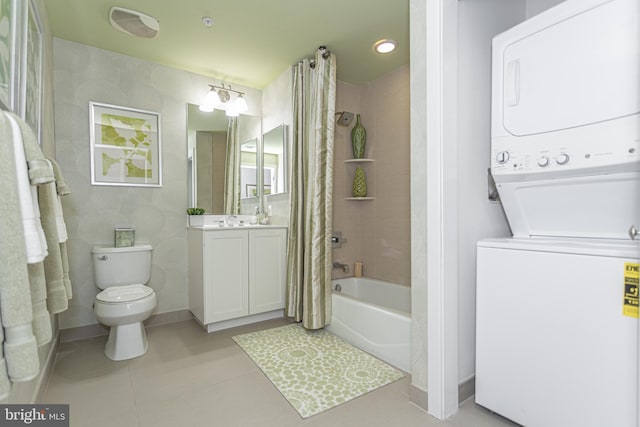 full bathroom featuring vanity, tile patterned flooring, toilet, stacked washer / drying machine, and shower / tub combo