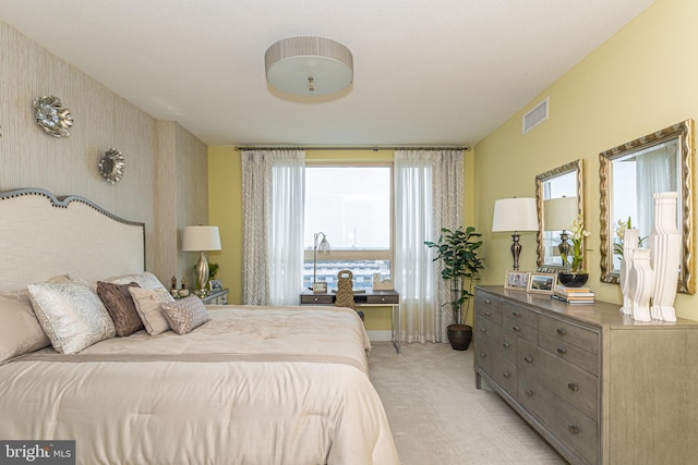 carpeted bedroom featuring multiple windows