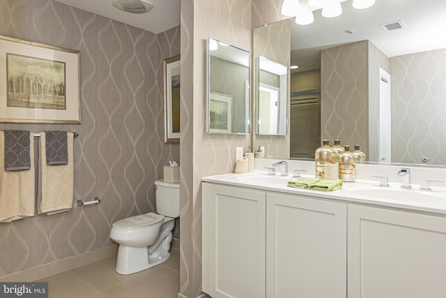 bathroom with tile patterned flooring, vanity, and toilet