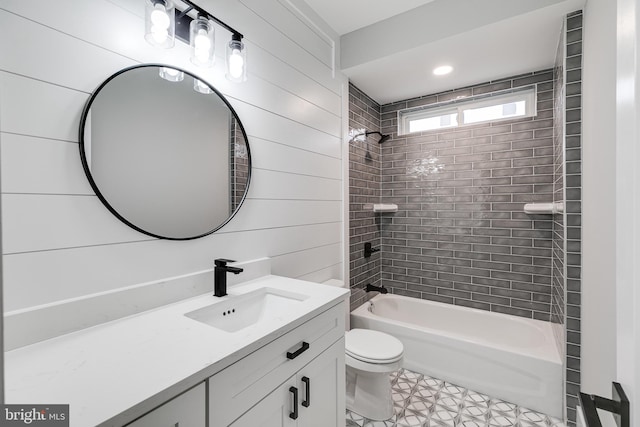 full bathroom with tile flooring, vanity, toilet, and tiled shower / bath combo