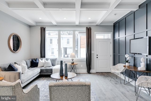 living room featuring coffered ceiling, beam ceiling, and light hardwood / wood-style floors