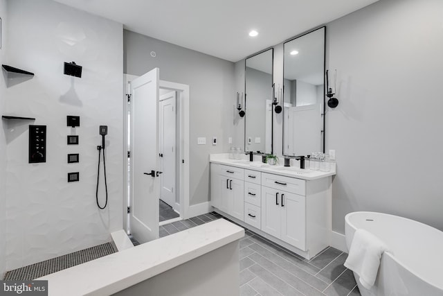 bathroom with tile floors, plus walk in shower, and double sink vanity