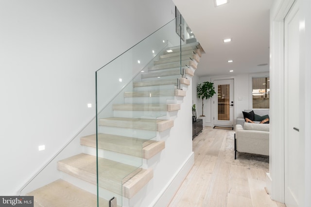 stairs with light wood-type flooring