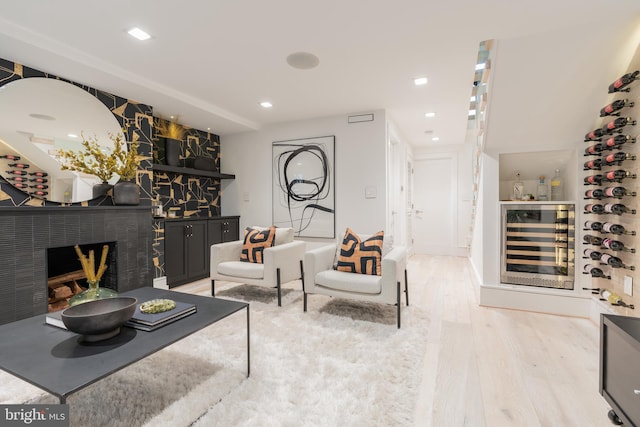 living room with beverage cooler and light hardwood / wood-style floors