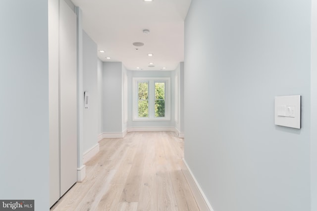 hallway with light wood-type flooring