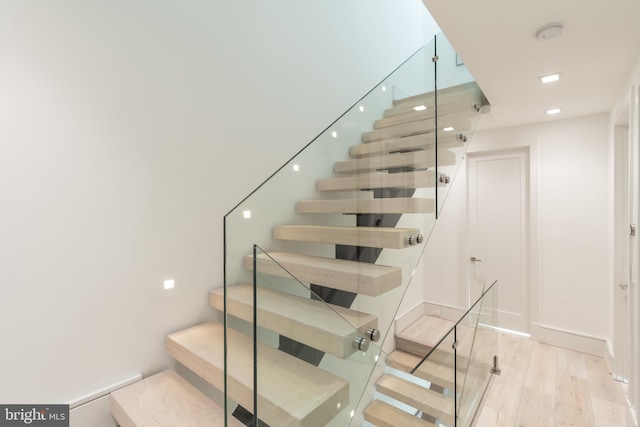 stairway featuring light hardwood / wood-style flooring