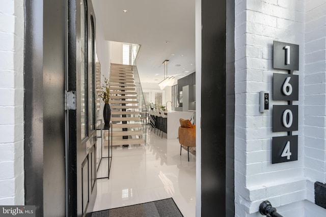 hall featuring light tile floors