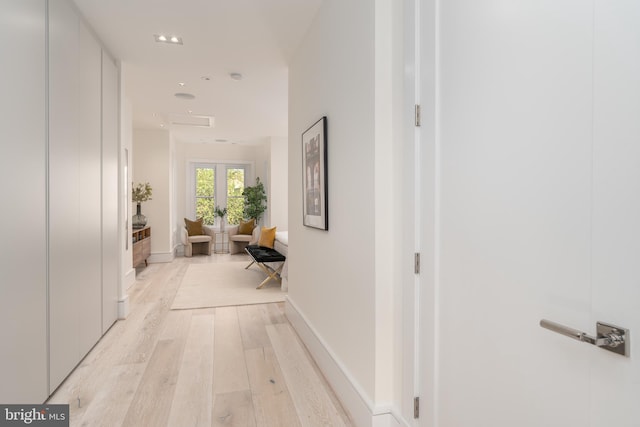 hall with light hardwood / wood-style floors