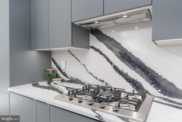 interior details with custom range hood and stainless steel gas stovetop