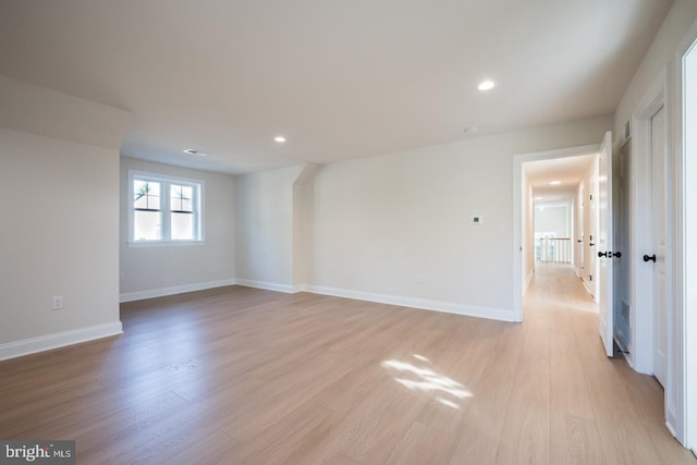 empty room with light hardwood / wood-style flooring