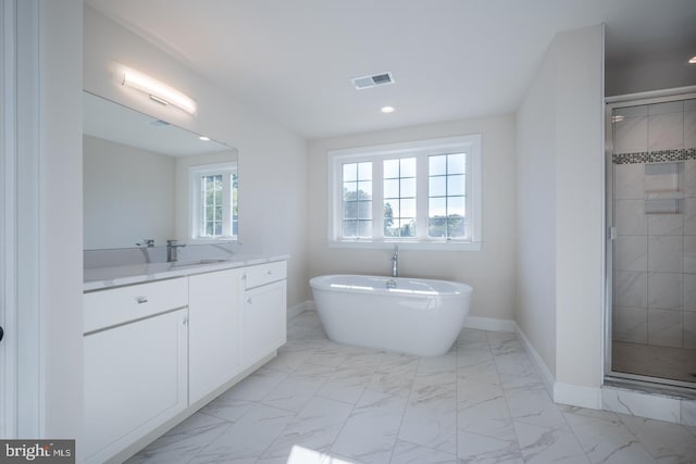 bathroom featuring tile flooring, plus walk in shower, and vanity