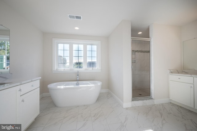 bathroom with vanity, tile flooring, and plus walk in shower