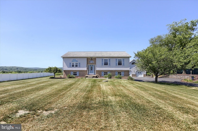 split foyer home with a front lawn